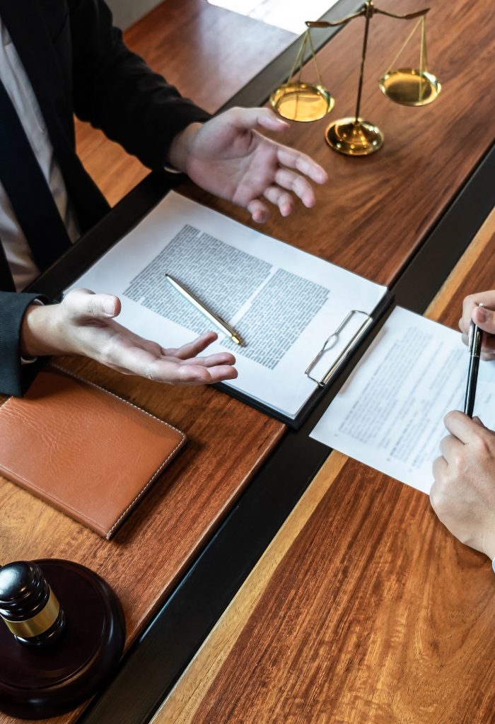 male-lawyer-discussing-negotiation-legal-case-with-client-meeting-with-document-contract-in-office.jpg